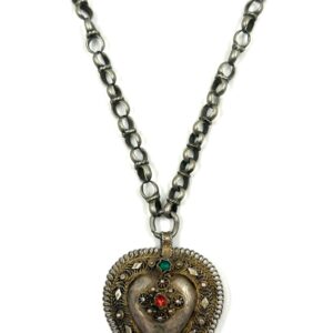 Silver heart-shaped pendant with decorative stones and chain.