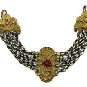 Traditional jewelry piece with bronze details, silver chains and red decorative stone