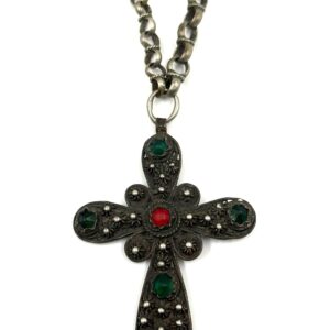 Traditional filigree cross pendant with green and red decorative stones.