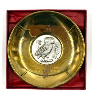 Decorative brass Lalaounis plate with silver owl motif in the center.