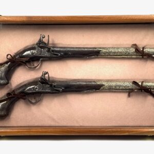 Pair of 19th century pistols with silver details, flintlock mechanism and engraved decorative barrel.